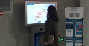 student using touchscreen to reserve a seat in the library