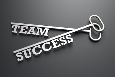 Two keys, one that reads "team" and one that reads "success"